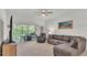 Cozy living room boasts an expansive sectional sofa and views of the outdoor patio at 13 Enclave Dr, Winter Haven, FL 33884