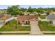 Aerial view of single-story home with well-manicured lawn and two car garage at 1366 Merrimack Pl, Davenport, FL 33837
