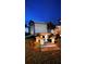 Backyard shed and outdoor dining set on a concrete slab with a mulch flower bed in a cozy space at 1366 Merrimack Pl, Davenport, FL 33837