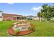 Spacious backyard with a picnic table and ample green space for outdoor activities and relaxation at 1366 Merrimack Pl, Davenport, FL 33837
