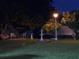 Backyard at night with a fountain and lawn furniture under the light of a streetlight at 1366 Merrimack Pl, Davenport, FL 33837