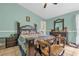 Comfortable bedroom with traditional furnishings, tile floors, and a view into an adjacent bathroom at 1366 Merrimack Pl, Davenport, FL 33837