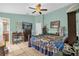 Serene bedroom featuring a ceiling fan, a TV, an ensuite bath, and comfortable furnishings at 1366 Merrimack Pl, Davenport, FL 33837