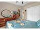 Cozy bedroom with floral bedding, dresser, and a mirror, offering a comfortable living space at 1366 Merrimack Pl, Davenport, FL 33837