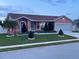 Attractive single-Gathering residence showcasing a tidy front yard, decorative shrubbery and a two-car garage at 1366 Merrimack Pl, Davenport, FL 33837