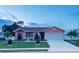 Inviting home with a lush front lawn, complemented by mature trees and a neatly paved driveway at 1366 Merrimack Pl, Davenport, FL 33837