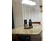 Close-up of kitchen island with decor, pendant lighting, storage and seating at 1366 Merrimack Pl, Davenport, FL 33837