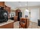 Bright kitchen boasts an island with seating, ample cabinet space, and modern appliances at 1366 Merrimack Pl, Davenport, FL 33837