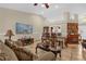 Spacious living room with a fireplace, dining table, comfortable seating, and entertainment center at 1366 Merrimack Pl, Davenport, FL 33837