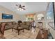 Relaxing living room with comfortable sofas, tile floors, and a sliding glass door to the outside at 1366 Merrimack Pl, Davenport, FL 33837
