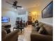Open-concept living room featuring tile floors, comfortable seating, and a dining area at 1366 Merrimack Pl, Davenport, FL 33837
