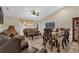 Inviting living area features tile floors, a vaulted ceiling, and an adjoining dining space at 1366 Merrimack Pl, Davenport, FL 33837