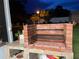 Outdoor brick grill with tiled base, surrounded by grass in the backyard at 1366 Merrimack Pl, Davenport, FL 33837