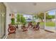 Inviting screened patio with unique wagon wheel furniture, perfect for outdoor relaxation at 1366 Merrimack Pl, Davenport, FL 33837