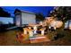 Picnic table next to a shed with surrounding flowerbed in the backyard at night at 1366 Merrimack Pl, Davenport, FL 33837