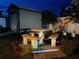 Picnic table next to a shed with surrounding flowerbed in the backyard at night at 1366 Merrimack Pl, Davenport, FL 33837