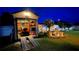 Open storage shed with riding lawn mower, next to a picnic table in the backyard at night at 1366 Merrimack Pl, Davenport, FL 33837