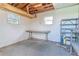 Unfinished basement with windows, workbench, and concrete walls at 2125 Hillcrest Rd, Auburndale, FL 33823