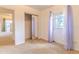This is a bedroom with carpet, closet with mirror, door with curtains and walls painted in a light color at 2125 Hillcrest Rd, Auburndale, FL 33823