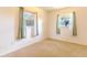 This is a bedroom with carpet, windows, curtains and walls painted in a light color at 2125 Hillcrest Rd, Auburndale, FL 33823