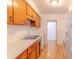 Functional kitchen featuring wood cabinets, laminate countertops, and light wood flooring at 2125 Hillcrest Rd, Auburndale, FL 33823
