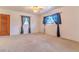 Spacious living room with neutral carpet, ceiling fan, and large windows with sheer curtains at 2125 Hillcrest Rd, Auburndale, FL 33823