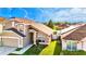 Aerial view of a tan two-story home featuring a two-car garage and a green front lawn at 2169 Rose Blvd, Winter Haven, FL 33881