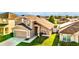 Aerial view of a tan two-story home featuring a two-car garage and a green front lawn at 2169 Rose Blvd, Winter Haven, FL 33881