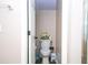 Cozy bathroom with a white toilet, neutral walls, a wastebasket, and accessories atop the toilet at 2169 Rose Blvd, Winter Haven, FL 33881