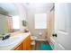 Functional bathroom featuring a vanity, toilet, mirror, and a shower with a decorative curtain at 2169 Rose Blvd, Winter Haven, FL 33881