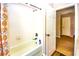 Shower and tub combo with a white showerhead and tile, next to the exit door at 2169 Rose Blvd, Winter Haven, FL 33881