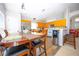 Eat-in kitchen with wooden cabinets, stainless steel refrigerator, long countertop, and dark wooden dining set at 2169 Rose Blvd, Winter Haven, FL 33881