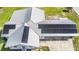 Aerial view of a home showcasing a modern metal roof with solar panels and a large yard at 2218 Melbourne Ave, Haines City, FL 33844