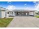 Large carport with solar panel roof and decorative concrete block in a light gray color at 2218 Melbourne Ave, Haines City, FL 33844