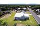 Exterior shot of a charming home with a metal roof and solar panels, perfectly set on a verdant lot at 2218 Melbourne Ave, Haines City, FL 33844