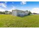 Landscaped yard highlights this charming gray home with a welcoming entrance and ample green space at 2218 Melbourne Ave, Haines City, FL 33844