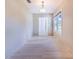 Light-filled hallway with tiled floors, white trim, and a modern chandelier above at 2218 Melbourne Ave, Haines City, FL 33844