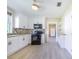 Spacious kitchen boasts white cabinets, tile backsplash, modern appliances, and wood-look tile flooring at 2218 Melbourne Ave, Haines City, FL 33844