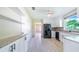 Modern kitchen with stainless steel appliances, granite counters, and sleek white cabinetry at 2218 Melbourne Ave, Haines City, FL 33844