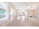 Bright, open-concept living space with elegant tiled flooring, neutral paint, and lots of natural light at 2218 Melbourne Ave, Haines City, FL 33844