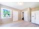 Bright room features neutral paint, tile flooring, natural lighting, and multiple doors for easy access at 2218 Melbourne Ave, Haines City, FL 33844
