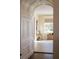 Hallway with dark wood floors, a window, and an archway with white trim at 2300 Scenic N Hwy # 51, Lake Wales, FL 33898