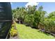 Large backyard with lush green grass, mature trees, and privacy fence at 237 Manatee Rd, Winter Haven, FL 33884
