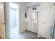 Neutral bathroom design with double sink vanity, white subway tile backsplash, and tiled floor at 237 Manatee Rd, Winter Haven, FL 33884