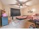 Cozy bedroom with fan, plush rug, and playful decor elements for a comfy atmosphere at 237 Manatee Rd, Winter Haven, FL 33884