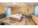 Bedroom with wood-look flooring, ceiling fan, wooden bedframe, and neutral walls with bright white trim at 237 Manatee Rd, Winter Haven, FL 33884