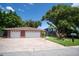 A beautiful home features a two-car garage and a front lawn, on a sunny day at 237 Manatee Rd, Winter Haven, FL 33884
