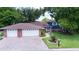 Charming two-story home with brick accents, a spacious three-car garage, and a well-manicured front lawn at 237 Manatee Rd, Winter Haven, FL 33884