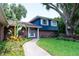 Inviting home features a brick facade, a well-manicured lawn, and beautiful landscaping at 237 Manatee Rd, Winter Haven, FL 33884