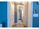 Hallway with storage closets, wood-look flooring, and a partial view of the bathroom at 237 Manatee Rd, Winter Haven, FL 33884